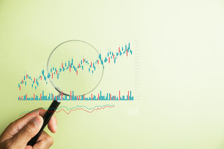 Quest for financial success,trader utilizesmagnifier glass to examine technical graph of stock...