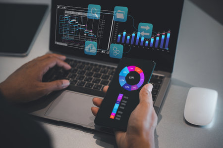 Analyst studying a business analytics report on a laptop computer with data charts and graphs....