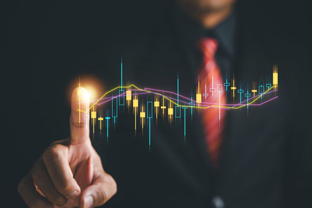 Progress and success in investment planning. Trader hand touches a growing virtual hologram stock on screen, emphasizing potential of stock market trading for achieving financial growth and prosperityの写真素材