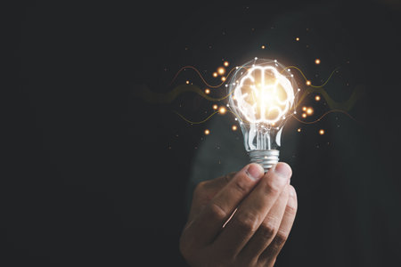Hand holding light bulb, signifying the concept of innovative ideas and creative thinking. bright...