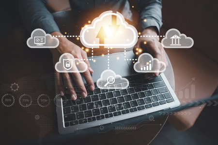 Man holding a laptop displaying cloud computing diagram with financial analytics and cyberspace communication in the background, a fintech concept for online business.の写真素材