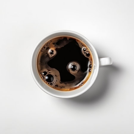 A freshly brewed cup of coffee with foam and a saucer, isolated on a white background, seen from above. AI Generative.の素材