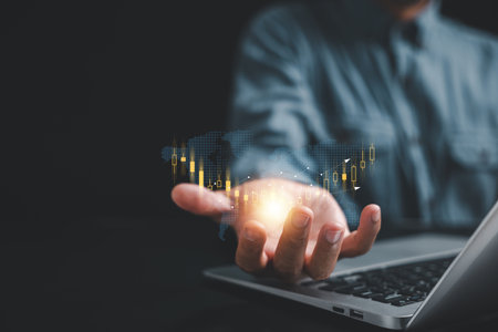 Close-up shot, Investor or trader man demonstrates a hologram of a stock growing chart on his palm. Stock market data analysis, trading strategies, and business growth concepts. Seize the opportunity.の写真素材
