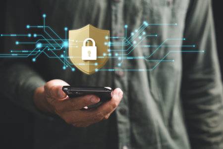 Ensure mobile privacy and security with a cybersecurity concept. Business professionals employ encryption and key icons on virtual interface shields to protect personal information on smartphones.の写真素材