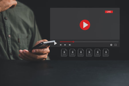 Engage with world of video streaming on smartphone, man touches screen to initiate live streaming. Embrace the convergence of technology and entertainment in the realm of social media and multimedia.の写真素材