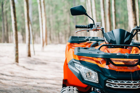 A quadbike competition in the autumn field, with the sun rising and the wheels kicking up mud and...
