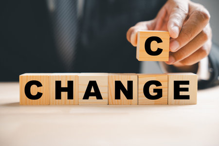 Hand flips wood block, revealing CHANCE from CHANGE. Success, strategy, and positive mindset...