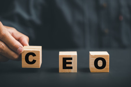 CEO symbol, Businessmans hand picks up wooden cube with CEO text. HR officer searches for leader and CEO. HR manager selects employee. Leader stands out from crowd. HR, HRM, HRD concepts.の写真素材