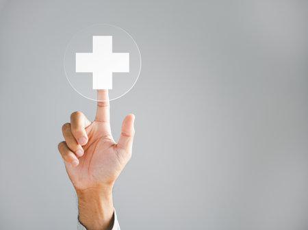 Businessman hand taps a virtual plus sign, representing positivity. Conveys ideas of increased benefits, progressive thinking, and a positive mindset. Business and success concept. positive thingの写真素材