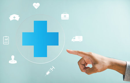 A hand touches a plus icon, underlining health, medicine, and insurance significance in family business. Puts spotlight on hospital access and welfare health service expansion.の写真素材