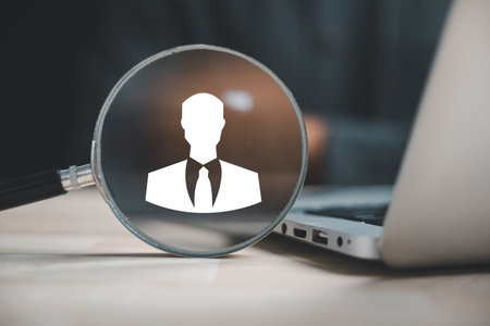 HRM impact Magnifier glass highlights manager icon on circle wooden, signifying its influence on human resource development, recruitment, and leadership success. employees selectionの写真素材