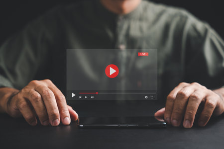 Man enjoying video streaming on virtual screen with a smartphone, unlocking a world of live sport, movies, and music. Experience the concept of online content on a mobile phone.の写真素材