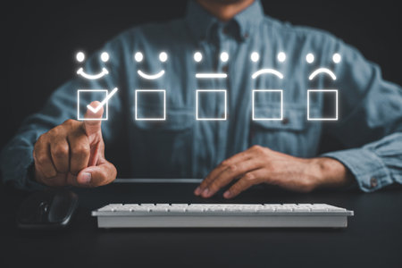 Man using keyboard computer finger touching rate smile face and evaluate services, select a popup five star icon for good feedback review. Business and technology conceptの写真素材