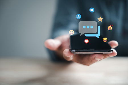 Connected through technology man on phone chats live, discussing social network concepts. Chat box icons appear, representing digital communication trends.の写真素材