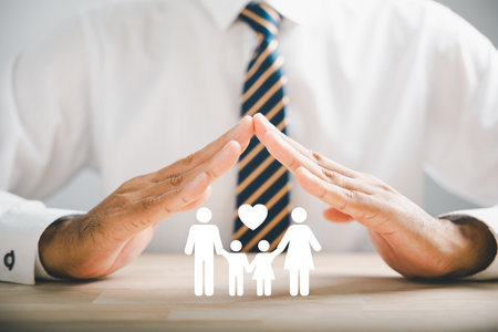Supportive family insurance concepts. Businessman protective gesture next to family silhouette. Icons for family, life, health, and house insurance. Highlighting insurance concept.の写真素材