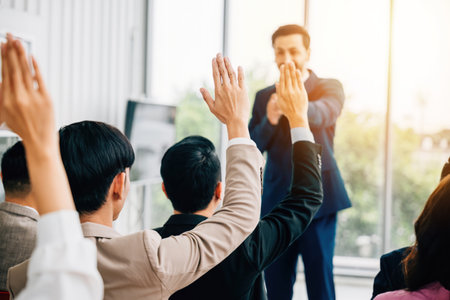 Engaging conference hands eagerly rise participants answer questions embodying active learning, diverse discussions and the spirit of cooperative success. This is essence of collaborative achievement.の写真素材