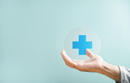 Hand grips plus icon for healthcare, highlighting benefits. Health insurance health concept, access to welfare health with available room. Conveys value addition in medical care.の写真素材