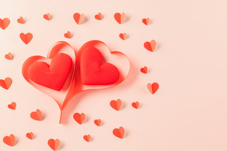Love and Valentines Day background. Top view flat lay of Ribbons shaped as heart and paper elements...
