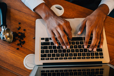 In the modern roastery office a multitasking business owner also a barista checks bean quality on...