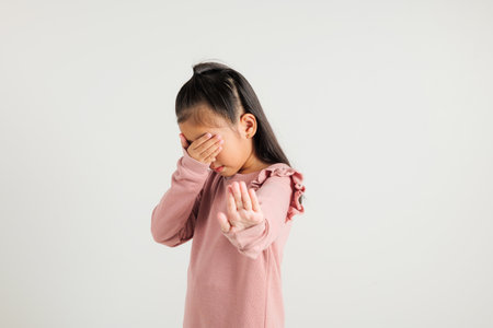 Stop hand of kindergarten child. Asian little kid girl doing stop sing gesture with palm of the hand...