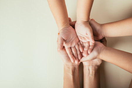 Top view of parents and kid holding empty hands together isolated. Symbolizing Family Day togetherness support and generational bonds.の写真素材
