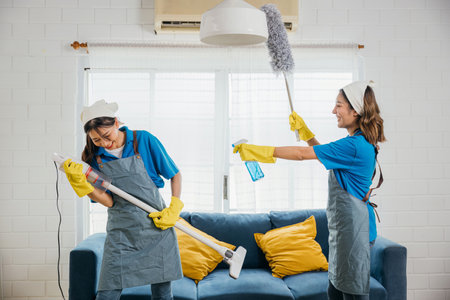 Maid cleaning melody, Asian woman enjoys vacuum guitar fun. Husband playful idea sparks singing dancing joyfully. Music-filled service adds excitement to household tasks. Cleaning is funの写真素材