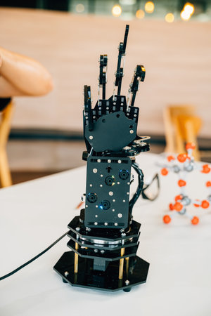 A black real robot hand presses or makes contact on a table surface illustrating futuristic artificial intelligence and technological evolution. A symbol of innovation in industry.の写真素材