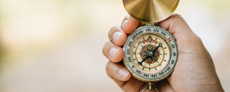 Amidst the forests beauty a close-up reveals a woman using a compass during her hike. With determination she holds the compass highlighting guidance and exploration.の写真素材