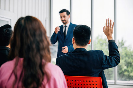 Group of business leaders presents their reviews in a meeting room, with a diverse audience of colleagues sitting, listening, and engaging. reflects essence of teamwork and productive discussions.の写真素材