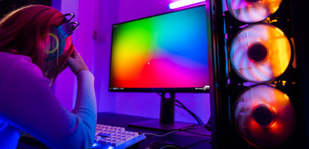 Game over. Angry Asian gamer wearing gaming headphones playing joystick console video game on computer PC neon light at home feeling sad disappointed about game losing, tournament player E-Sportの写真素材