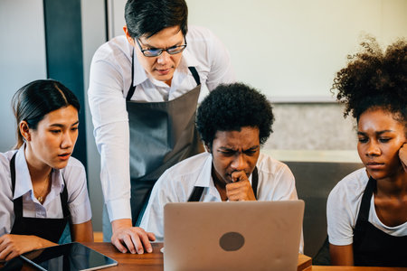 Coffee shop business brings joy fun pride to young entrepreneurs. Planning managing with laptop brings satisfaction. Baristas owners collaborate for success teamwork smiling faces.の写真素材