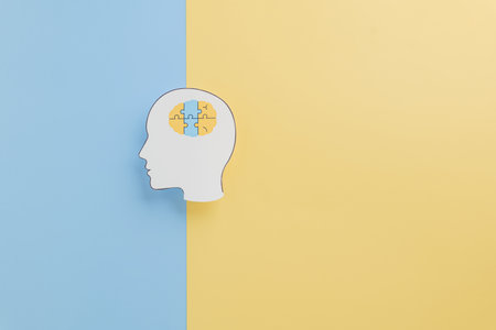 Down Syndrome awareness concept with brain jigsaw and head paper cut on blue and yellow background. Supporting Down Syndrome advocacy and spreading hope through awareness.の写真素材