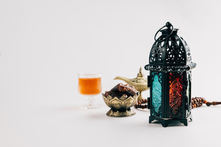 Holy Ramadan scene with dates, lantern, vintage oil lamp, and tea decor arranged beautifully on white background. Ramadan Kareem holyの写真素材