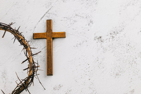 Palm Sunday theme, cross and crown of thorns on light textured background. Symbolizing Easter celebration and spiritual reflection.の写真素材