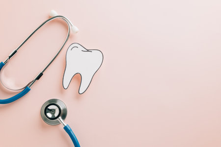 Tooth paper cut and stethoscope on pink for Dentist Day concept. Emphasizing dental, orthodontic, and oral health with a medical-themed mockup for awareness and postcards.の写真素材
