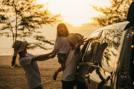 Asian family playing near car window at sunset feeling funny in holidays and relaxation together. Happy weekend travel enjoy summer at beach. summer vacation travel driving road trip conceptの写真素材