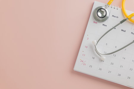 March calendar and stethoscope on pink celebrating Doctor Day. Highlighting health, medical appointments, annual exams, and doctor checkup scheduling.の写真素材