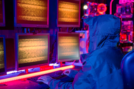 Woman wear hood sit front computer typing on keyboard in neon light, Gamer woman streaming game...