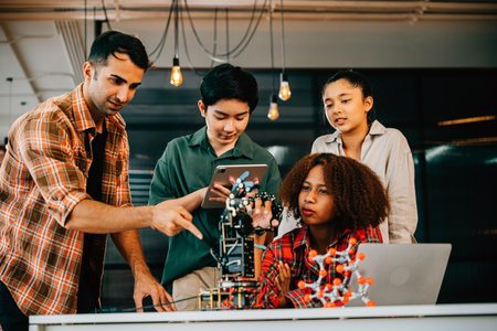 Students and teacher gathered in a classroom exploring a robotic arm for learning. Highlighting innovation teamwork and practical education in science and technology. Robot hand. technology conceptの写真素材