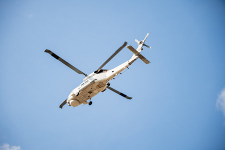 Helicopter in flight against blue sky demonstrating modern rescue and transport technology. New engine hovering capabilities. Pilot maneuvers small aircrafts speed and angles.の写真素材