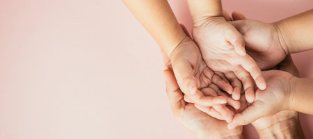 Parents and kid holding empty hands together isolated on color background. Family day celebrating togetherness and support.の写真素材