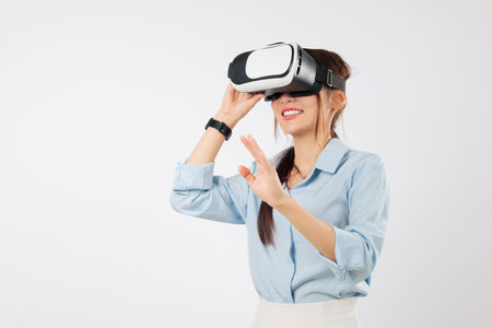 Asian woman with vr headset glasses touches virtual reality future game, businesswoman explores new...