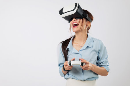 Game moments intensify while woman plays exciting VR game wearing headset, entering new world of reality and streaming fun. isolated studio white backgroundの写真素材