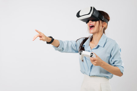 VR game excitement with Young Asian woman pointing during VR game play, immersed in joyful virtual...