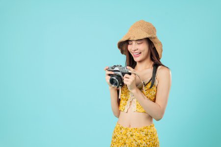 Happy travel asian tourist woman camera vacation smile holding film camera, wearing summer floral...