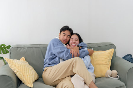 Winter day, happy couple, family people enjoy home indoor comfort, young man and woman embrace...