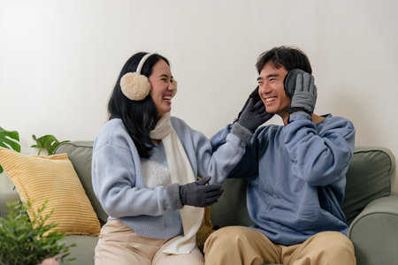 Winter day brings happy couple family home, people enjoying indoor comfort, feeling warmth together during cold winter weather, creating special holiday memories.の写真素材