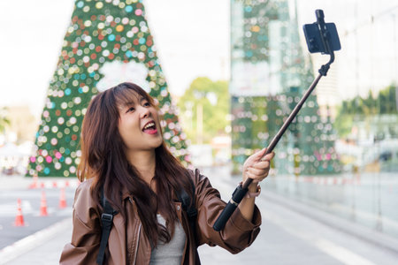 Asian woman shopping, fashion lifestyle with bags, people enjoy mall outside, posing with phone on...