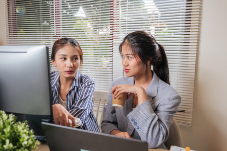 Asian young women business team work online, home office colleagues learn, collaborate, discussing project ideas on computer, effective remote teamwork for business success.の写真素材