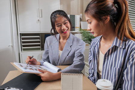 Young business women work at home office, team people learn and collaborate online on new project designs, sharing creative ideas, making informed decisions.の写真素材